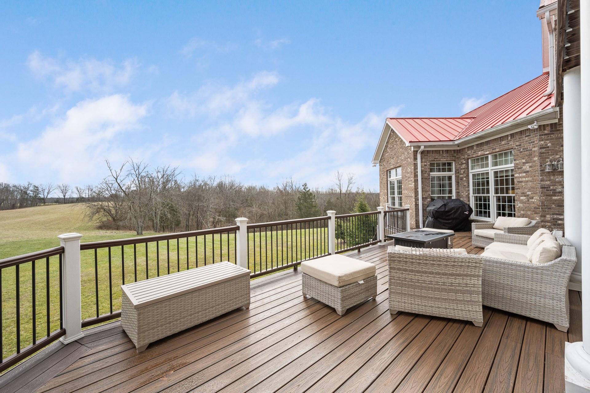 The Commonwealth deck with outdoor seating and field views